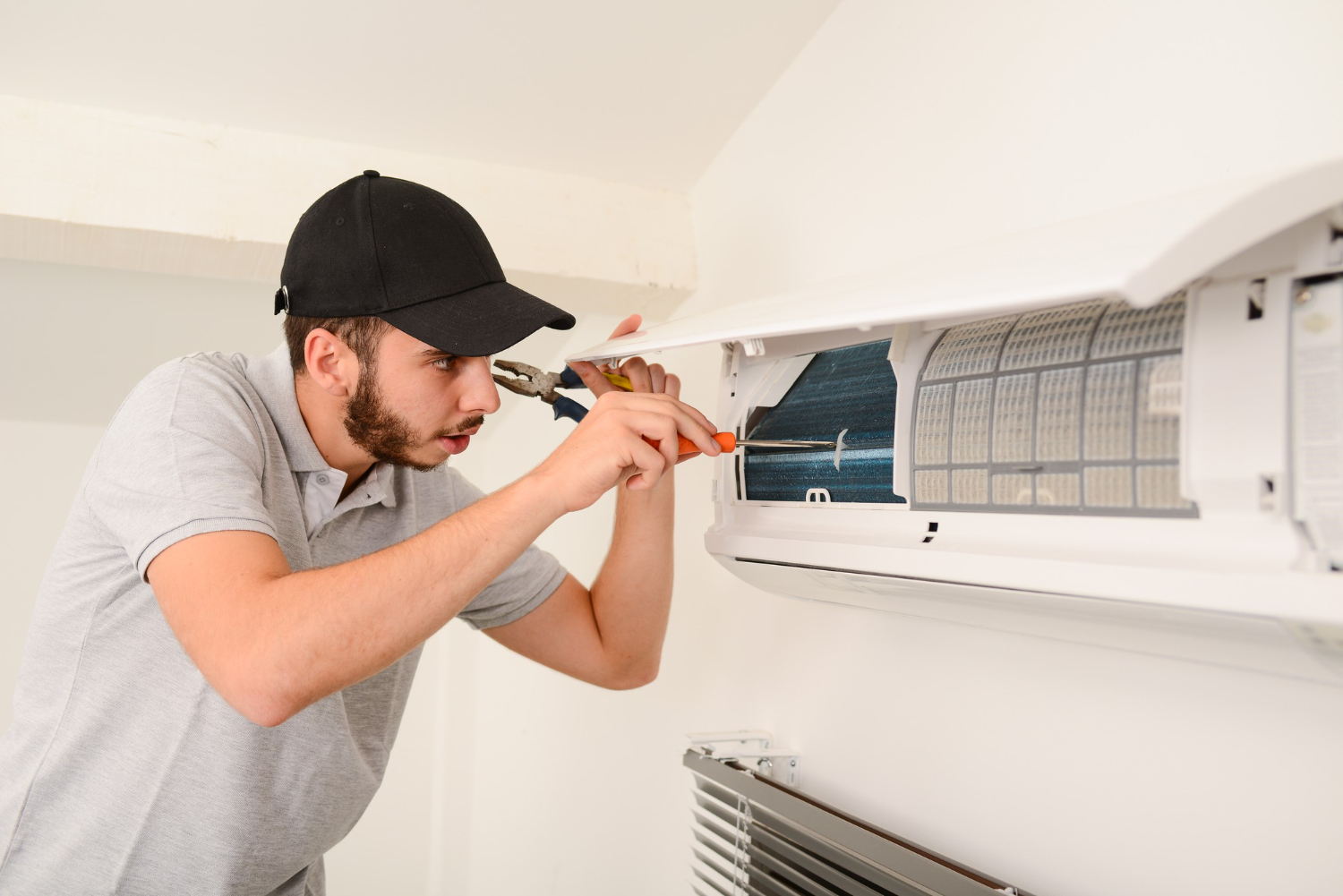 electrician-cleaning-air-filter-indoor-unit-air-conditioning-system-client-house